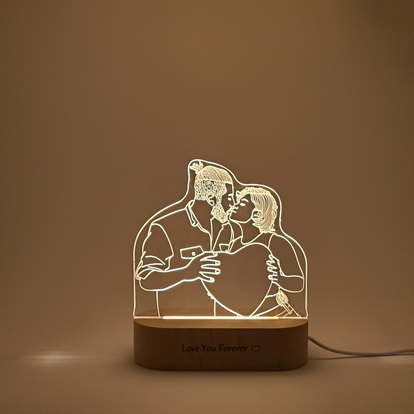 Personalized 3D lamp featuring a couple kissing, set against a simple, unadorned background in soft lighting.