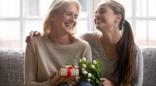 Daughter gifting her mother a thoughtful Christmas present filled with love.