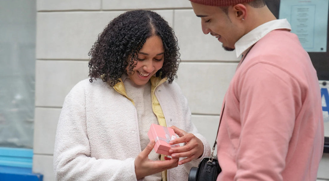 A man gifting his girlfriend, creating a romantic and thoughtful moment.