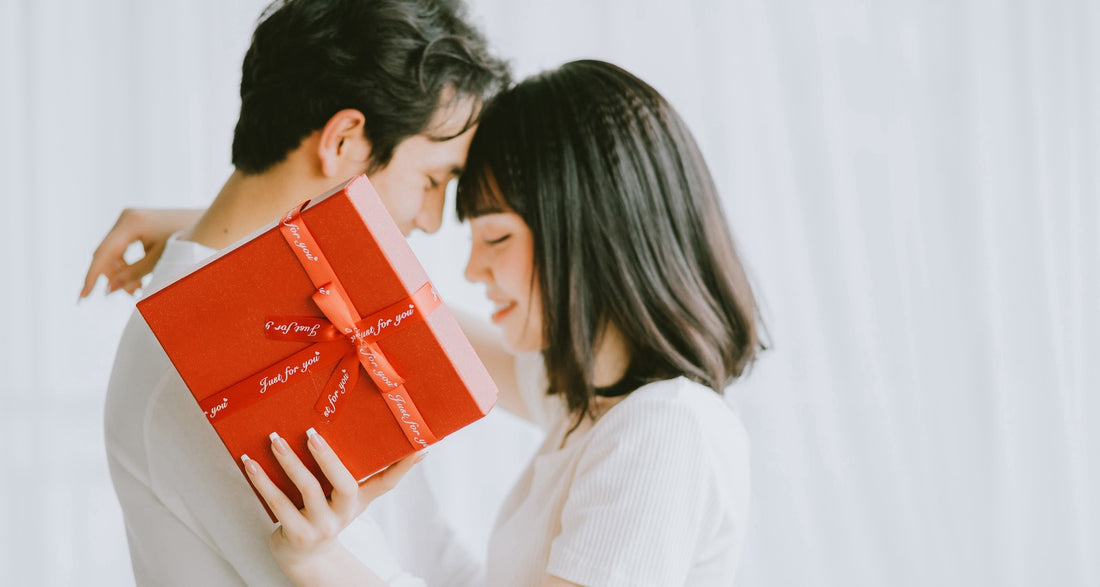 Couple celebrating Valentine's Day, with a girlfriend gifting her boyfriend a personalized light gift, creating a warm and loving atmosphere together