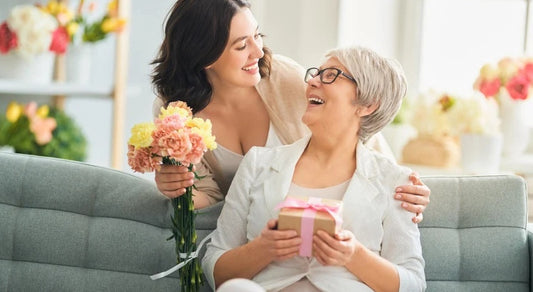 Mother receiving a thoughtful Mother’s Day gift from her daughter, smiling with joy and appreciation.