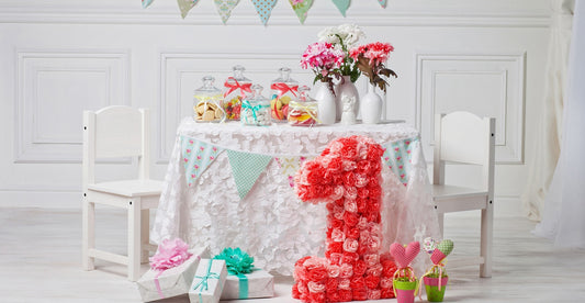 1st birthday party with personalized baby gifts, including baby night lamps, photo lamps, and colorful decorations, creating a memorable celebration.