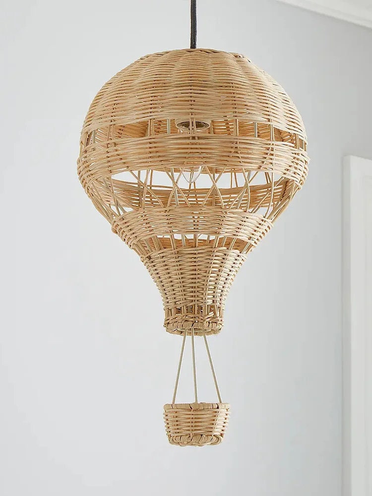 A hand-woven bamboo hot air balloon lamp hanging on roof with white background