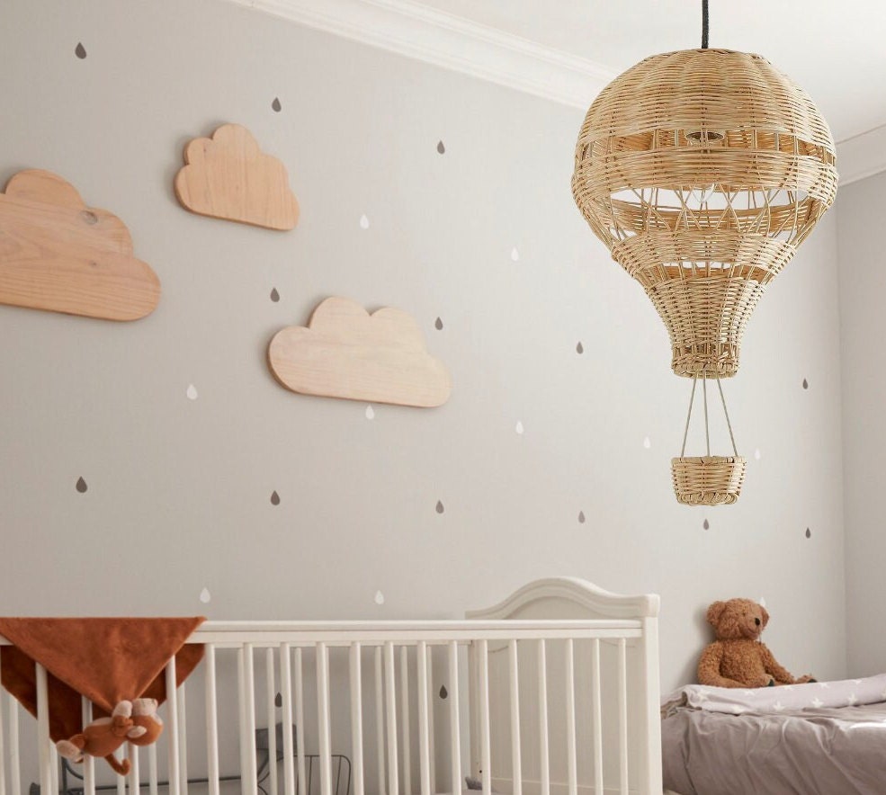 A hand-woven hot air balloon lamp made of bamboo, beautifully displayed in a decorated children's room.