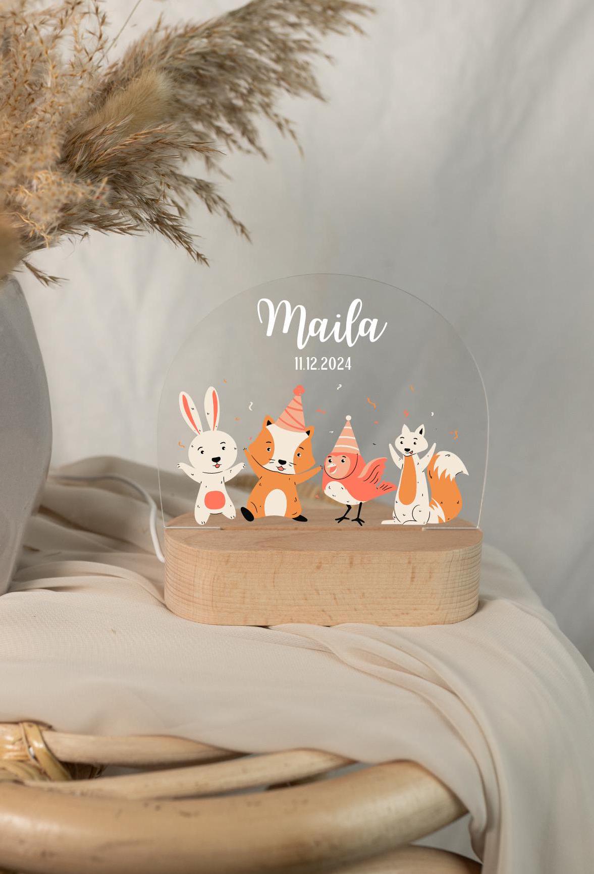 A personalized baby night light withanimal motif, captured in a close-up view under daylight, with a boho-style background.
