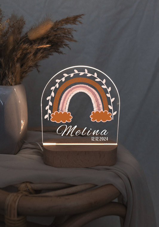 Personalized rainbow bedside lamp for girls in a dark baby room.