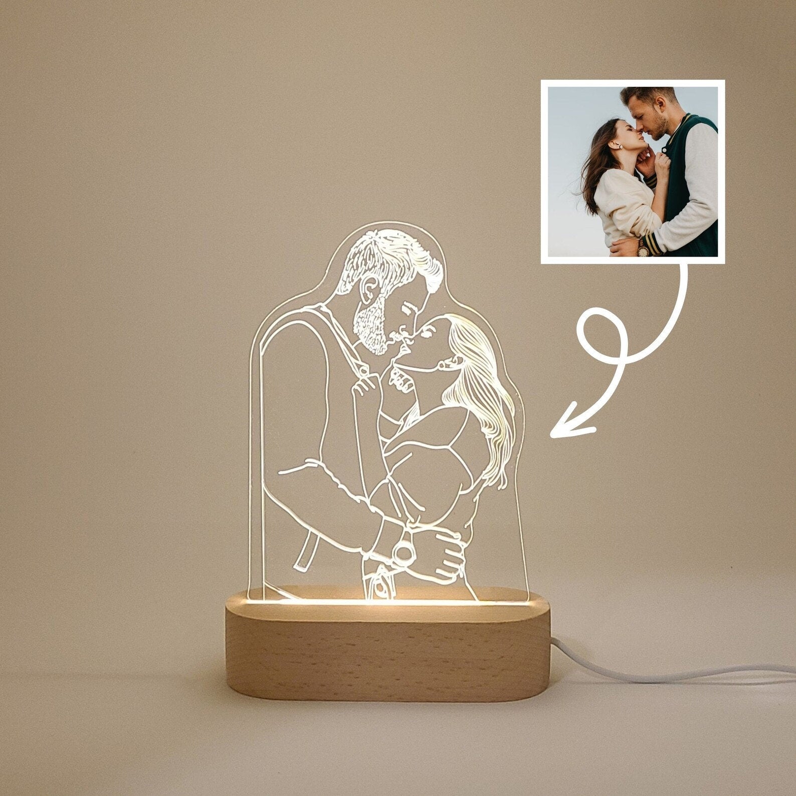 Individual 3D photo lamp featuring a couple embracing in daylight, showcasing the engraved image on the lamp.