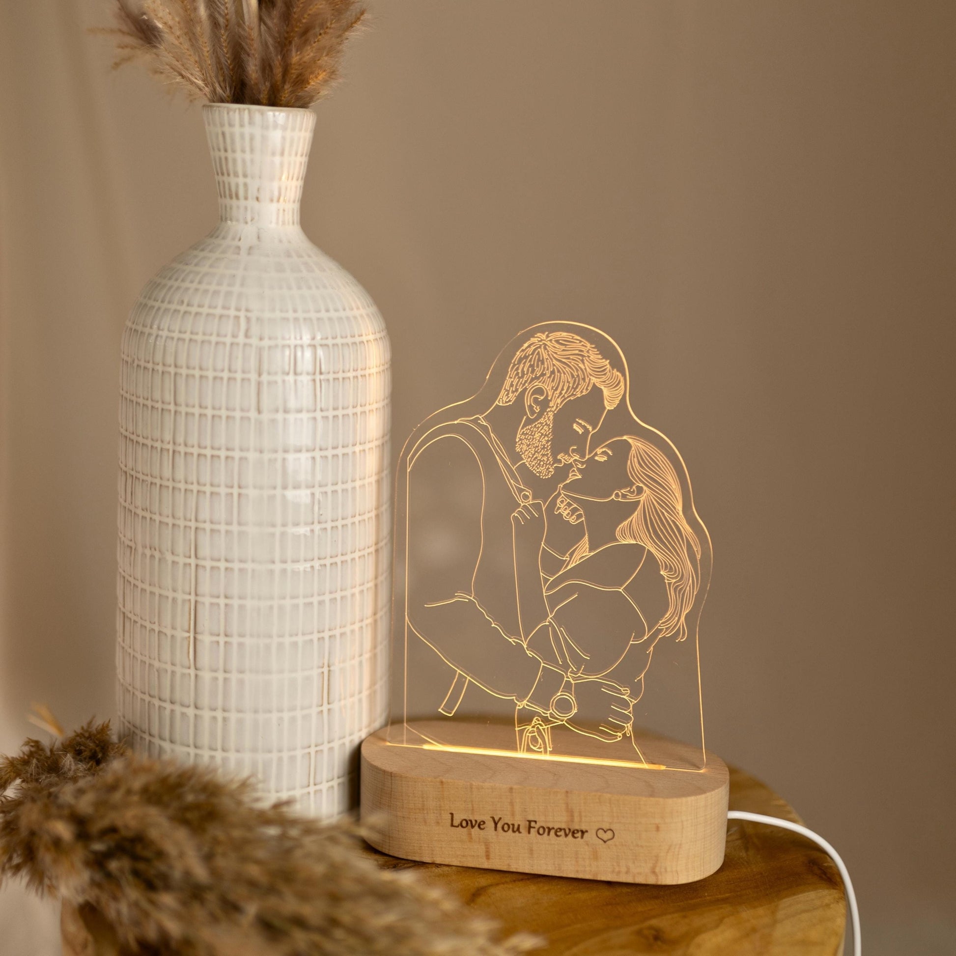 Personalised photo lamp for couples, photographed next to a vase.