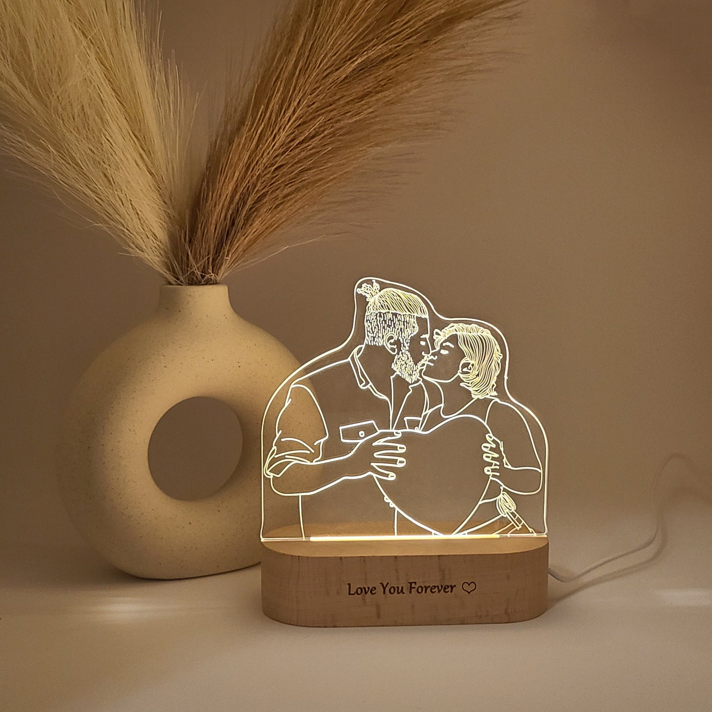 Personalized 3D lamp featuring a couple kissing, illuminated with warm lighting.