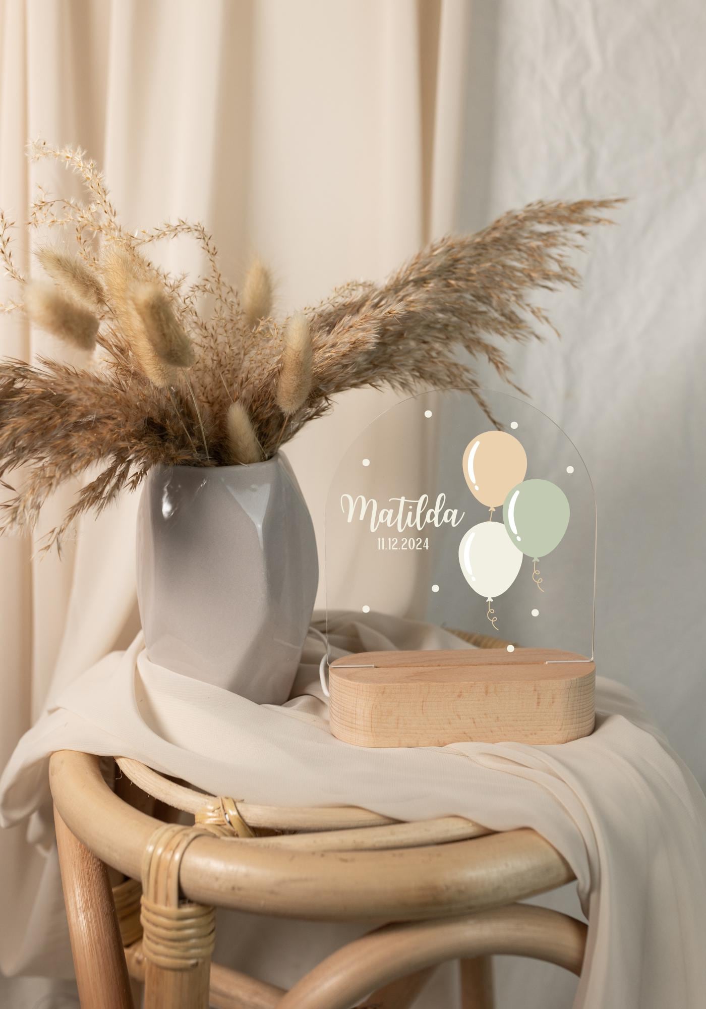 Personalized balloon night light displayed in daylight, featuring boho-style decorations in the background.