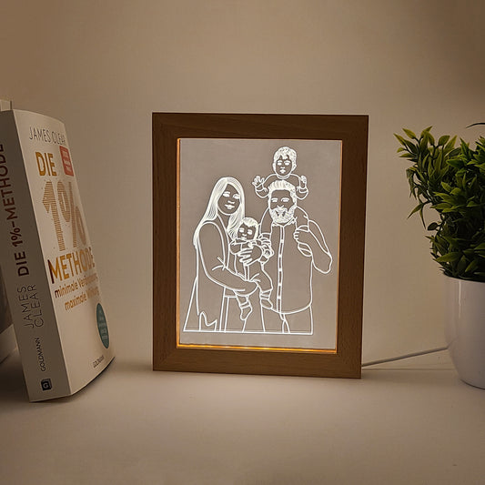 Personalized family photo frame lamp on a desk, captured in low light.