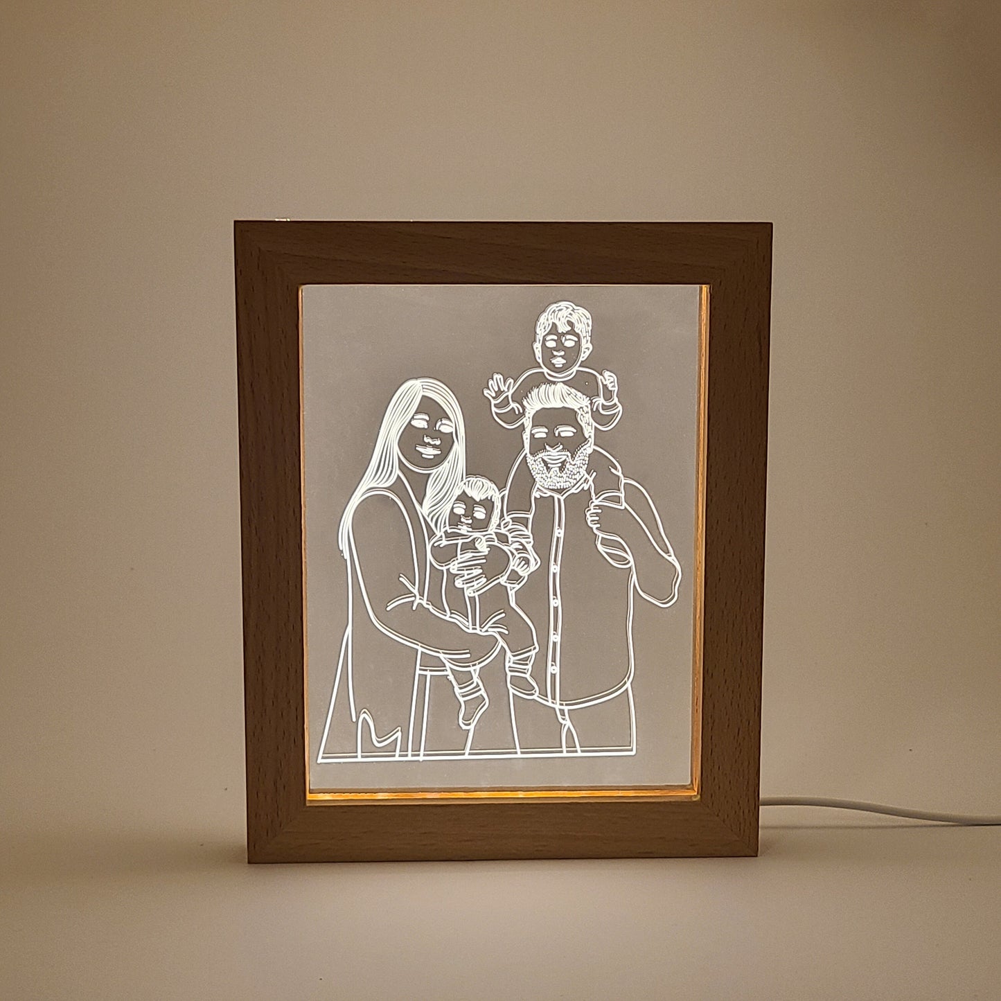 Personalized family photo frame lamp on a desk in low light, with a simple background