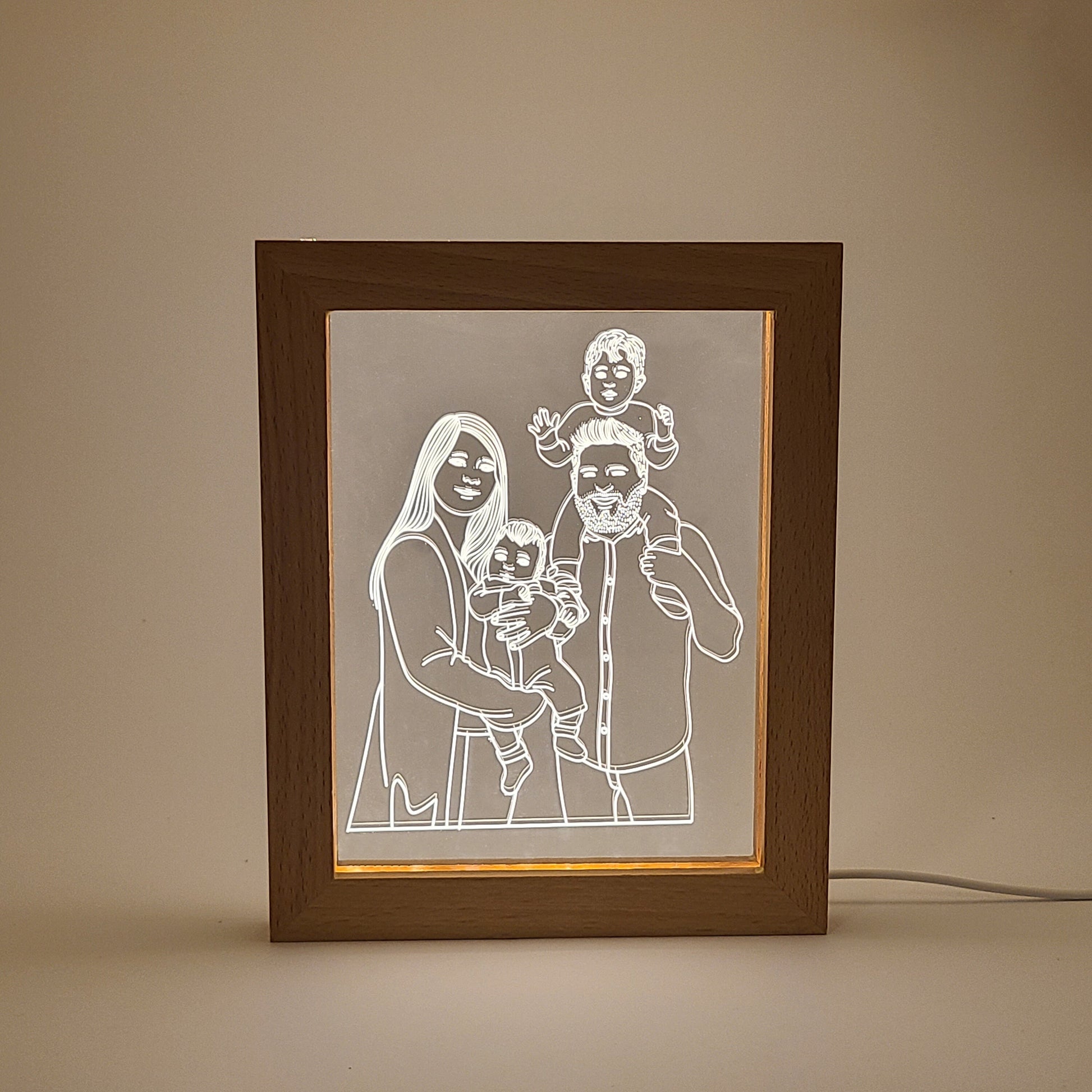 Personalized family photo frame lamp on a desk in low light, with a simple background