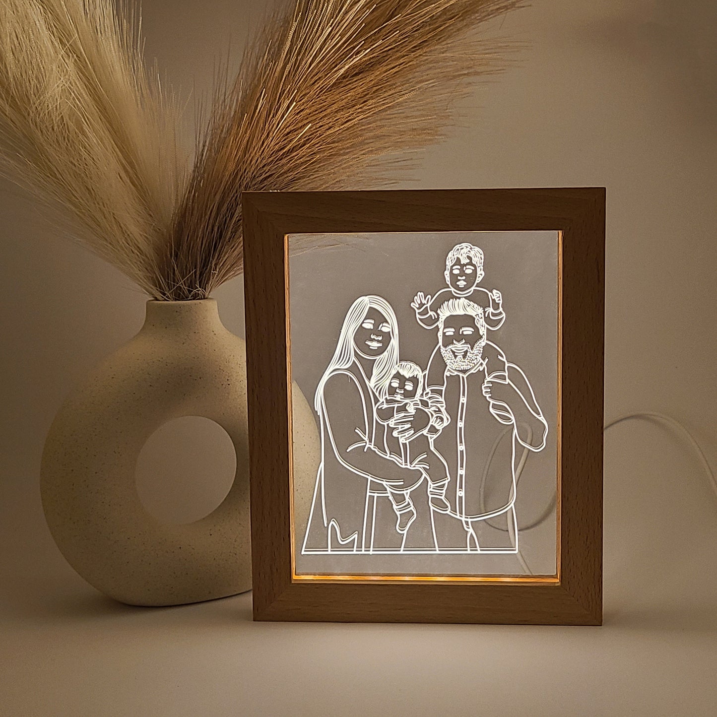 Personalized photo frames featuring an engraved family photo, displayed in low light and close-up view