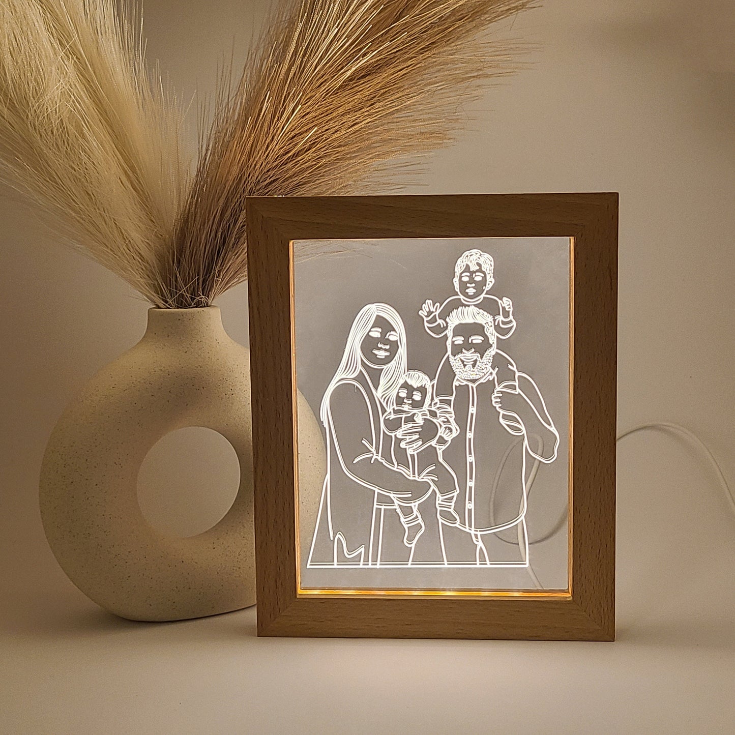 Personalized photo frames featuring an engraved family photo, displayed in low light for a warm ambiance.
