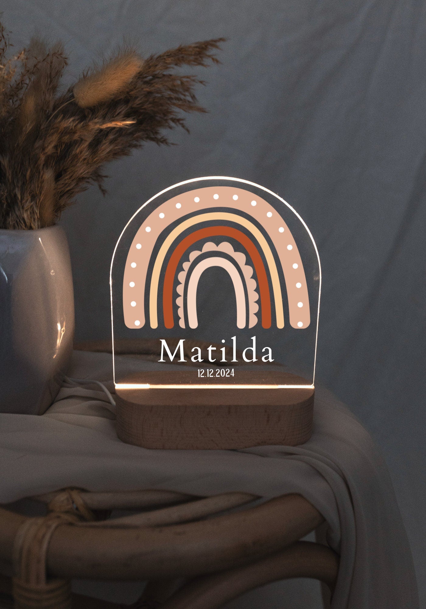 Rainbow baby night light, captured in dark light and close-up view with boho style background