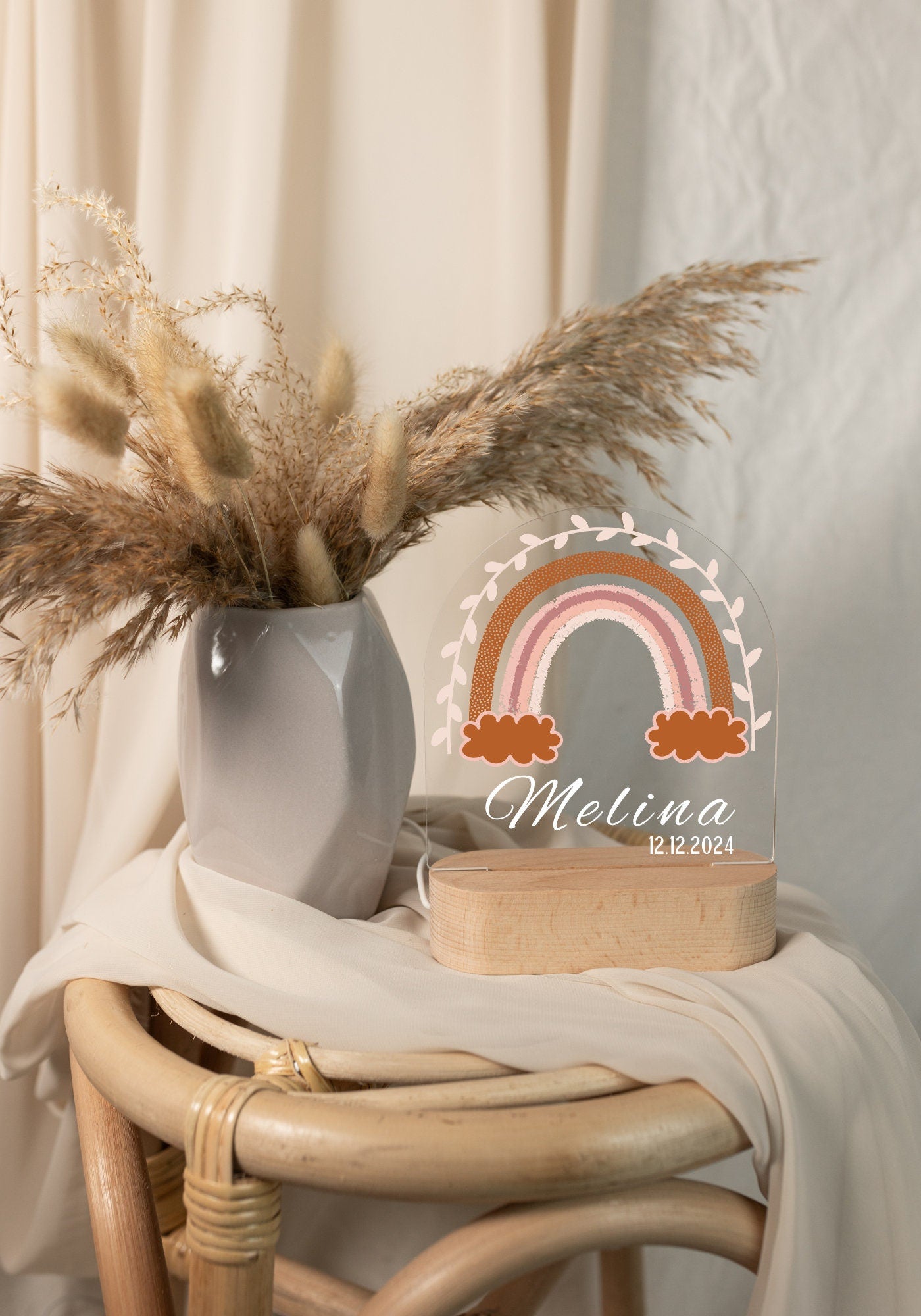 Rainbow night light personalized with a name and date of birth, captured in daylight against a boho-style background.