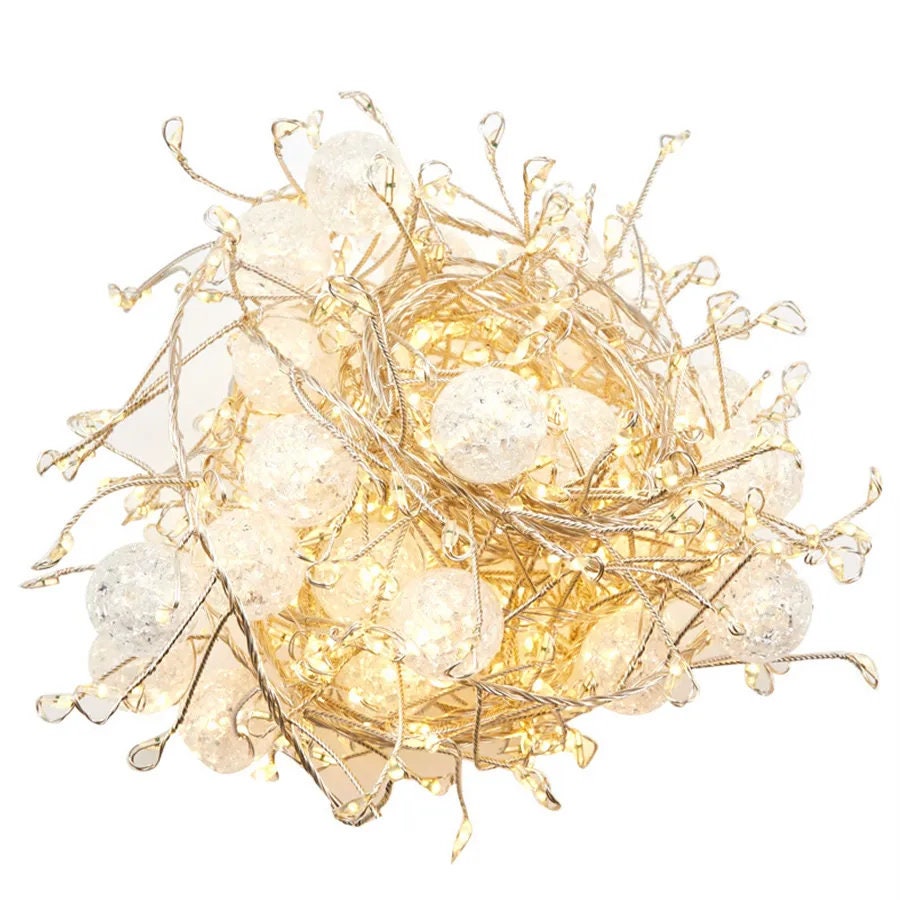 Fairy lights with crackling crystals and a warm white glow with white background