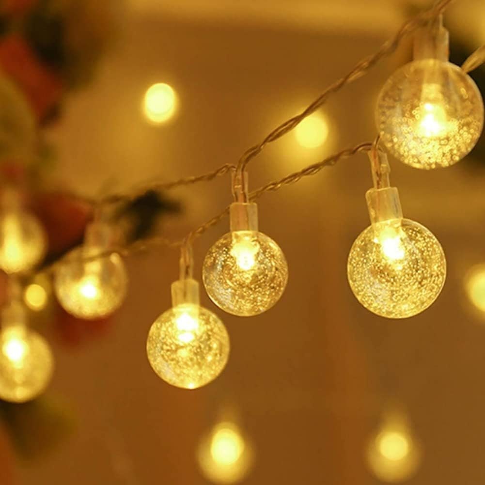 Outdoor light chain in crystal ball shape in warm light, giving cozy atmosphere